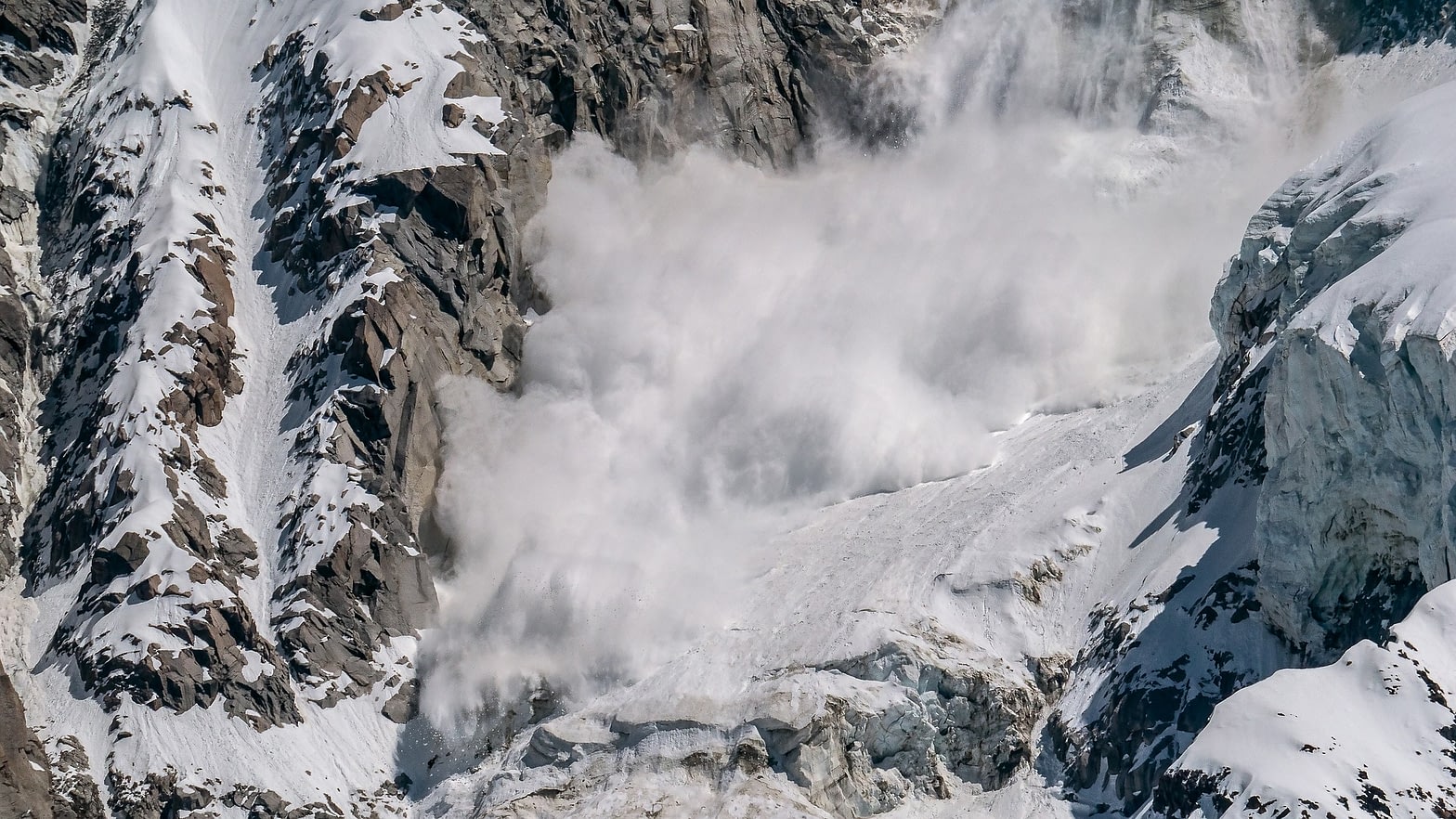 An avalanche cascades down a mountain - yourmoneyvehicle.com