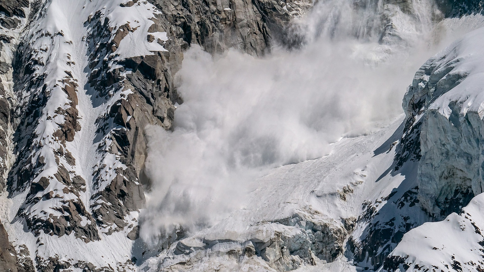 An avalanche cascades down a mountain.